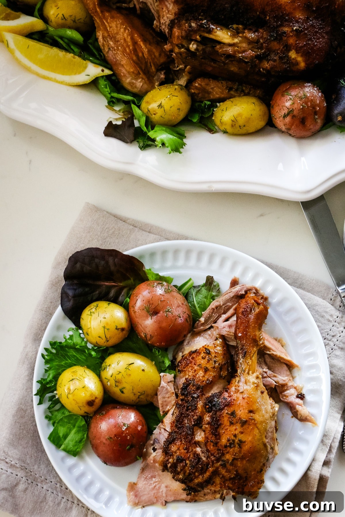 Slow Cooker Duck Recipe for Tender, Flavorful Meat 6 Whole duck seasoned with garlic and marble potatoes and a quarter-leg portion plated with potatoes and herbs.