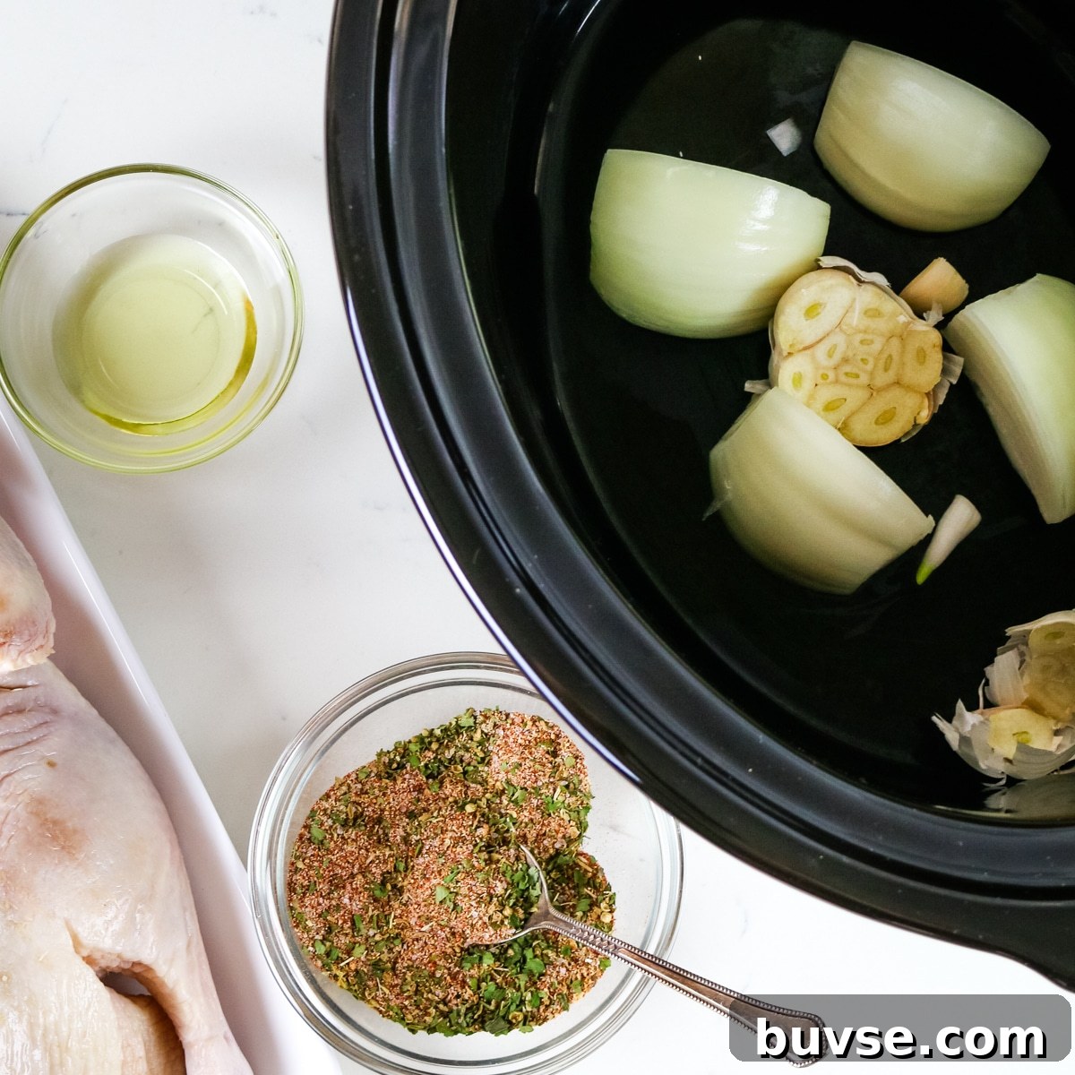 Slow Cooker Duck Recipe for Tender, Flavorful Meat 8 Duck on a white plate, oil & salt in a glass bowl, and garlic and onion in the slow cooker.