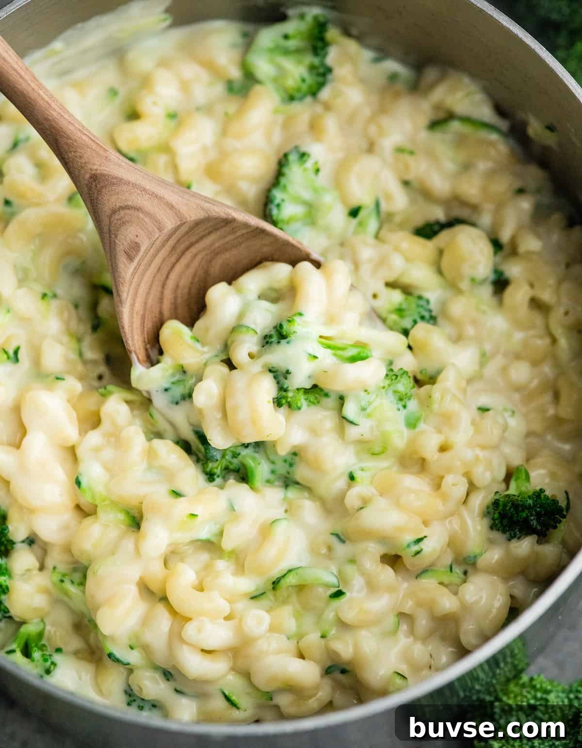 wooden spoon scooping vegetable mac and cheese