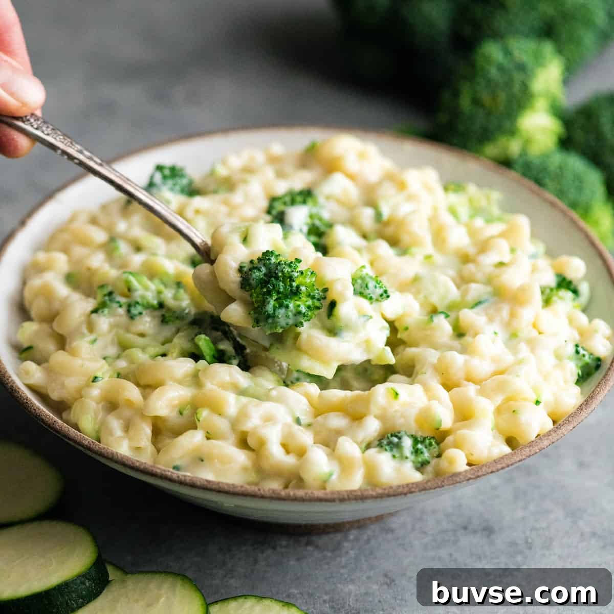 spoon scooping a serving of vegetable mac and cheese