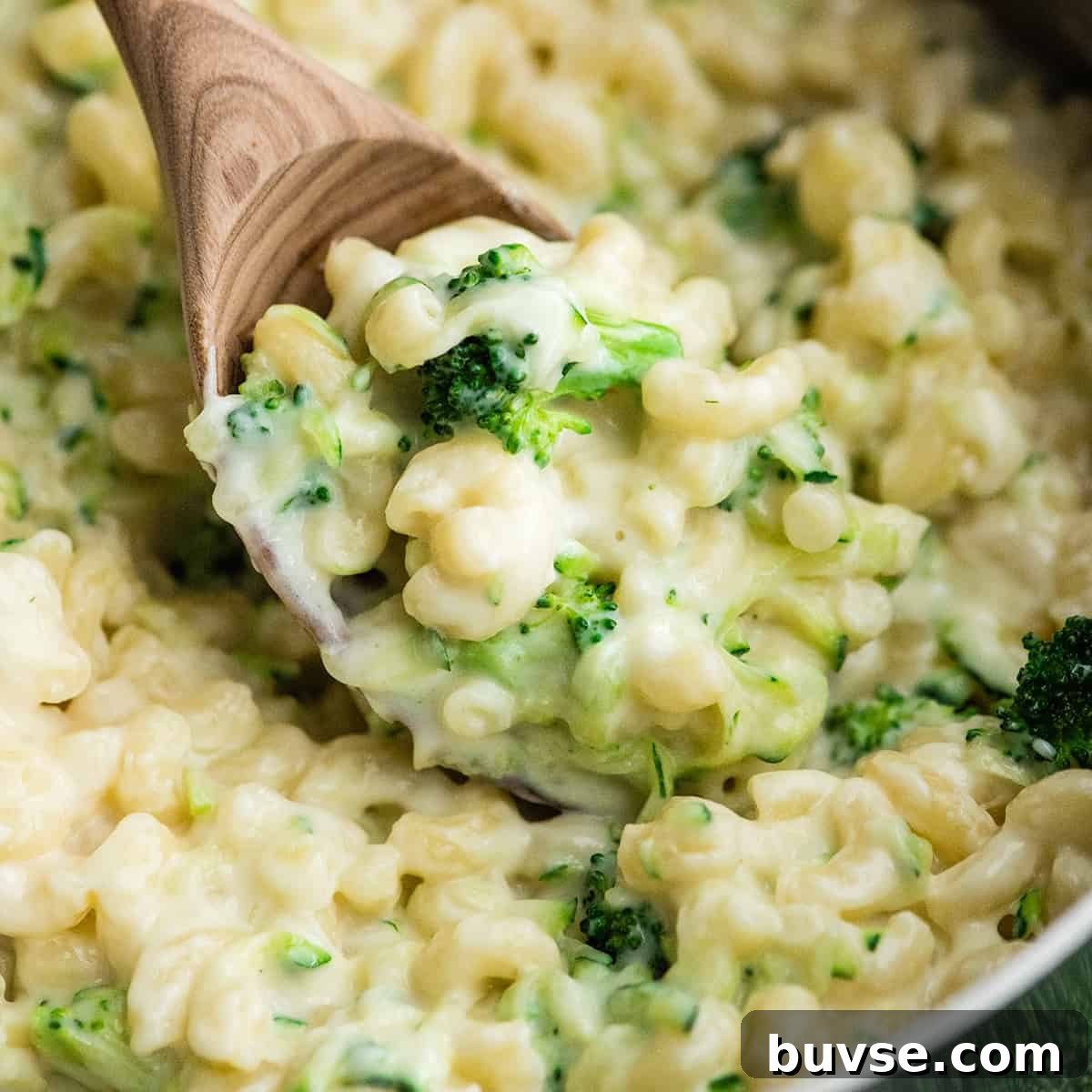 ladle scooping mac and cheese from a pot
