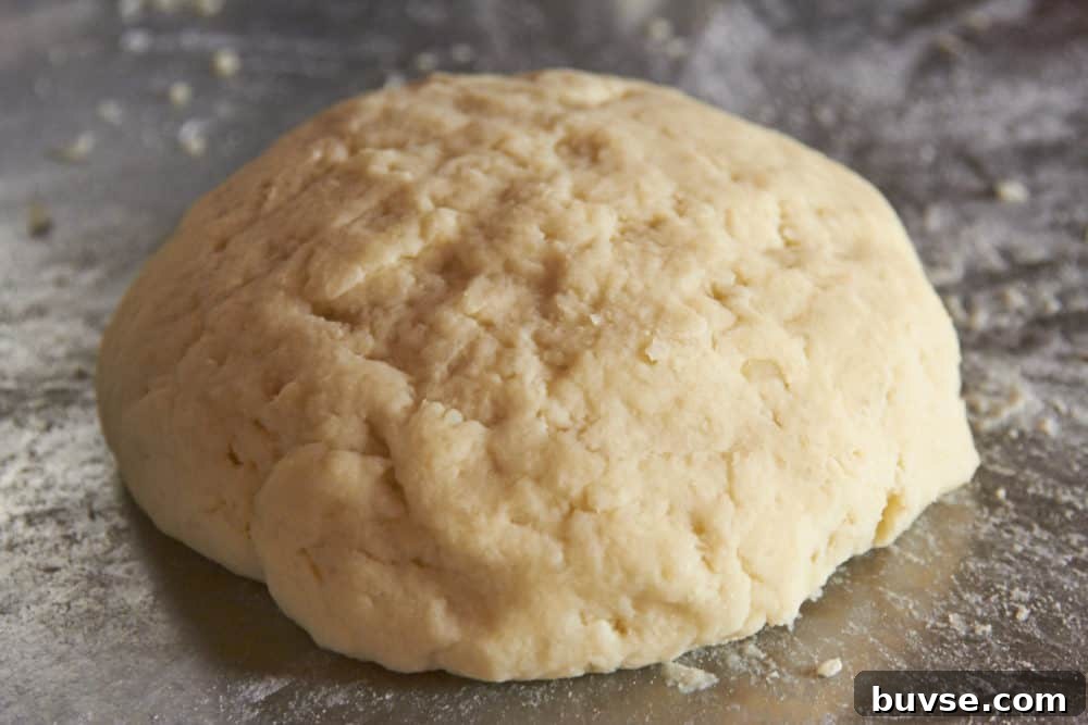 A ball of gnocchi dough on a stainless steel counter.