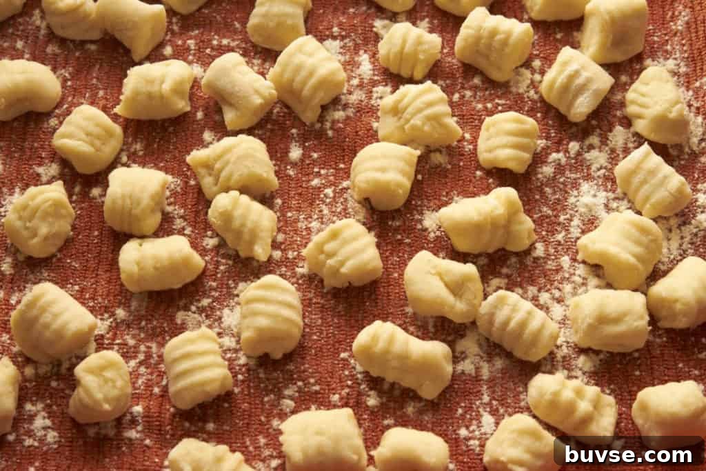 Gnocchi dumplings on a floured kitchen towel.