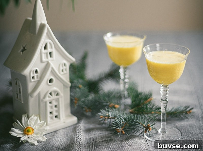 Zabaglione (Zabaione) Recipe: Classic Italian Egg Custard 2 two elegant cut glass dessert glasses full of creamy soft yellow classic zabaglione styled with quaint christmas decor