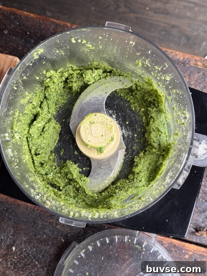 Creamy green pesto in a processor