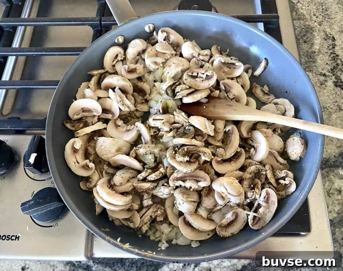 Creamy Vegan White Sauce Lasagna Recipe 3 I am sautéing mushrooms, onions, shallots, and garlic in a pan on the stove.