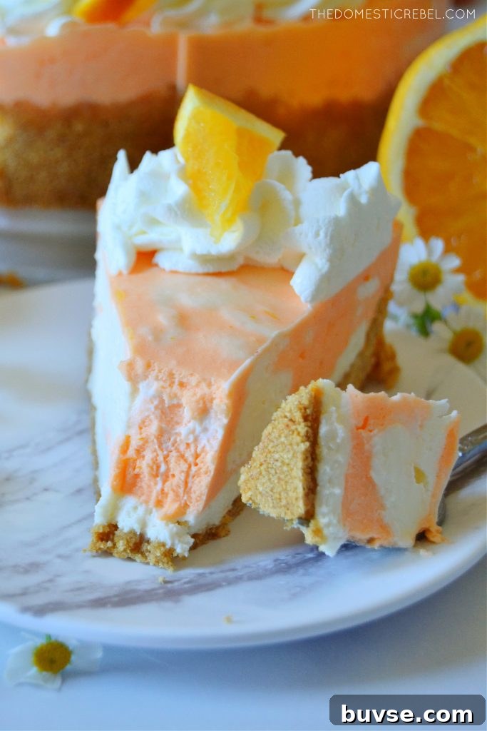 photo of orange creamsicle cheesecake with a bite missing