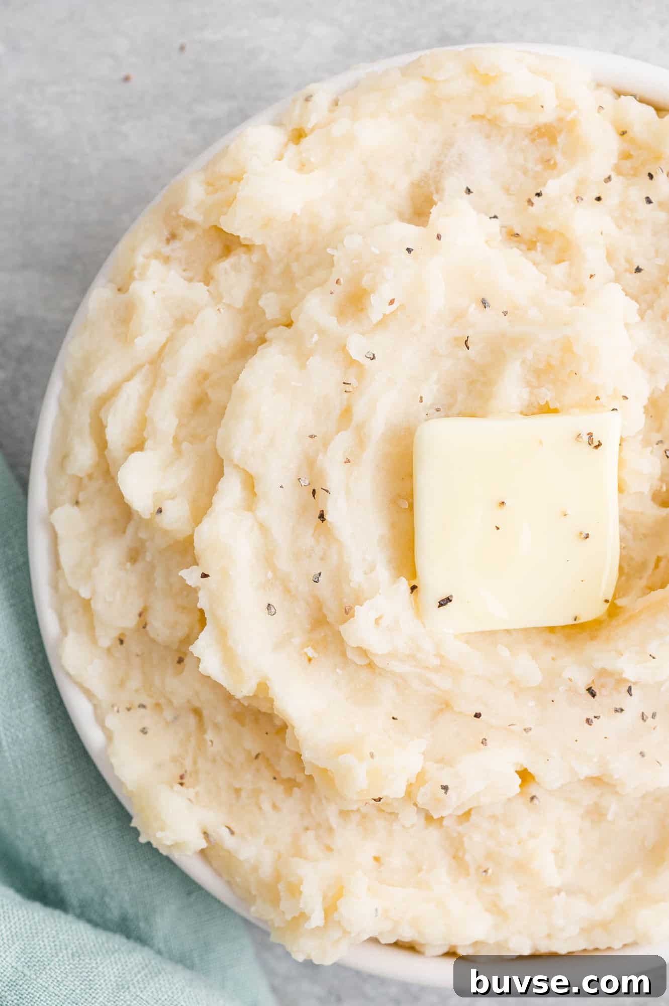 Crockpot mashed potatoes topped with butter.