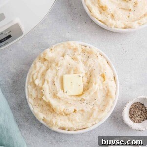 Crockpot mashed potatoes in a white bowl.