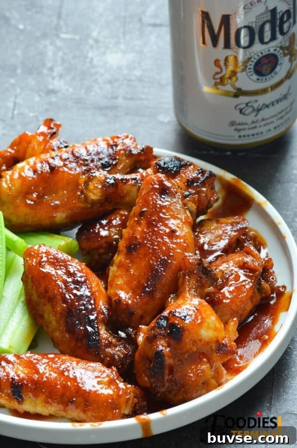 instant pot bbq chicken wings frozen served on a white plate with beer