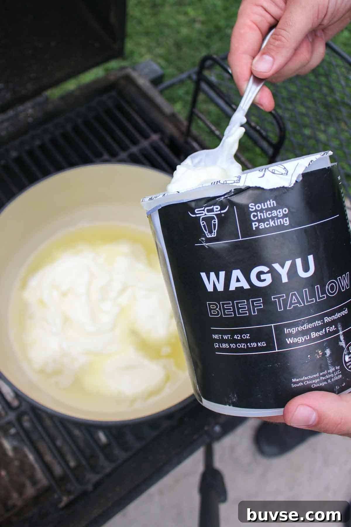 Adding South Chicago Packing's Wagyu beef tallow to the dutch oven so that it can heat up for frying. 