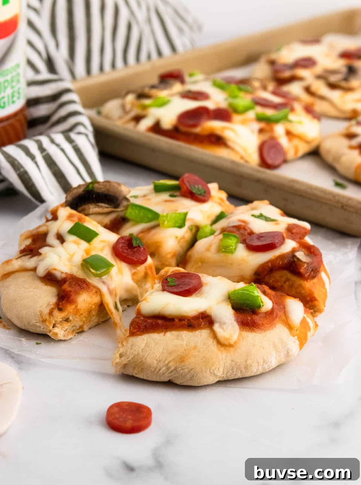 Pizza cut into fourths with pan in background.