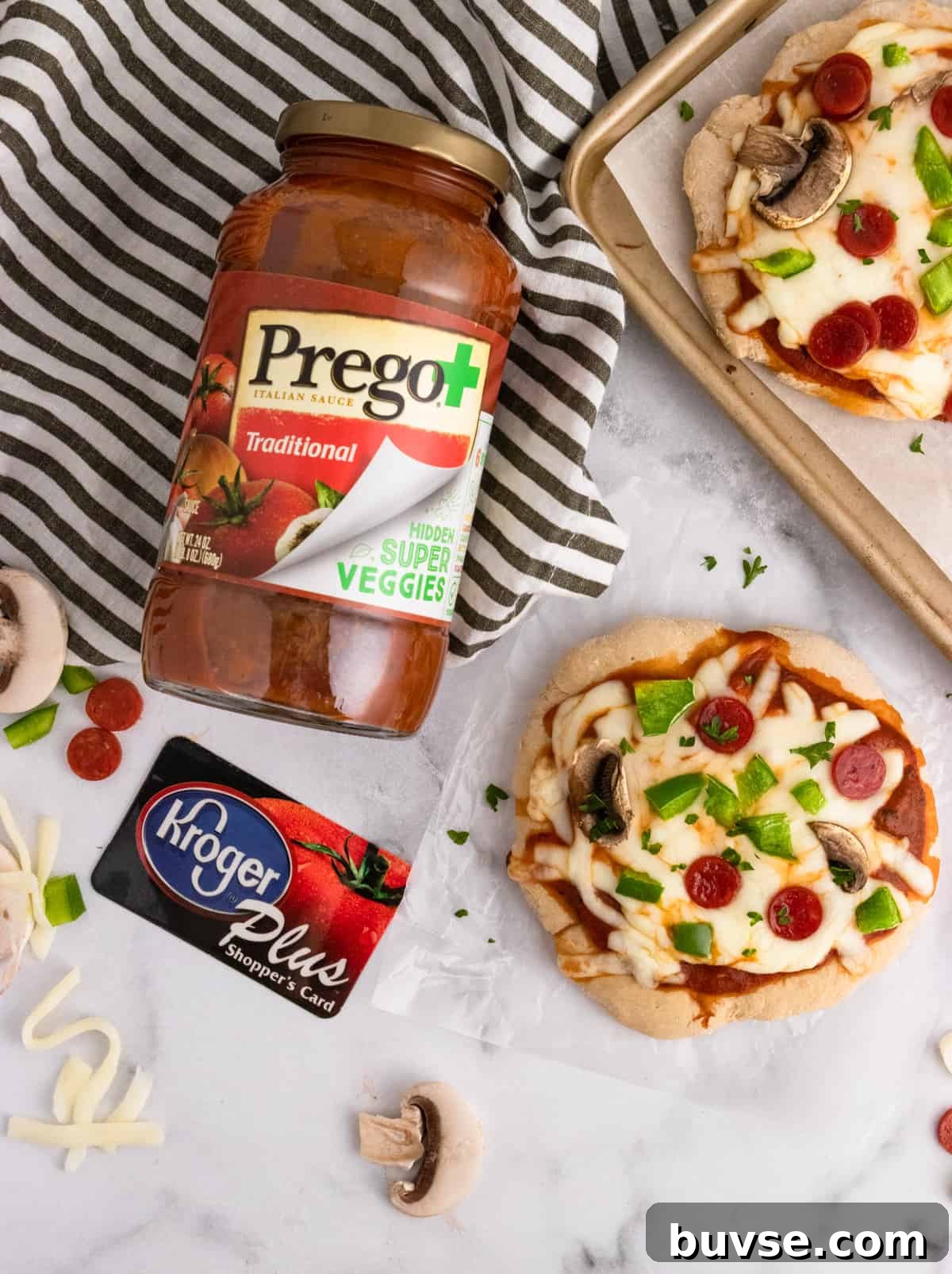 Prego and Kroger card with pizza on counter.
