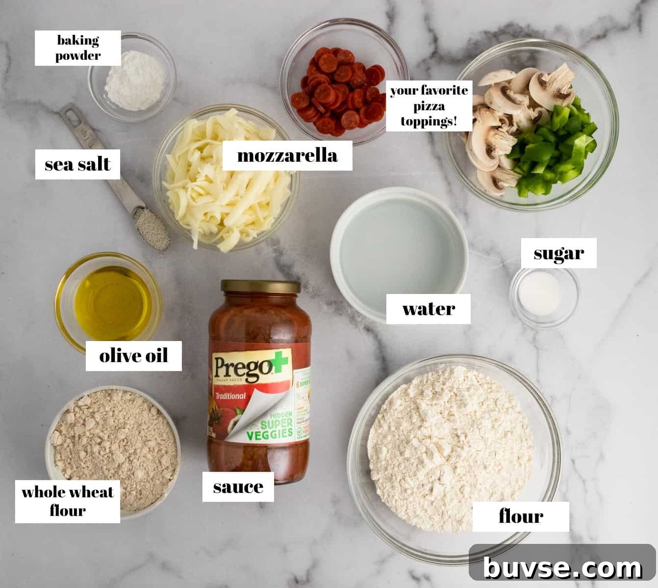 Pizza ingredients labeled on counter.