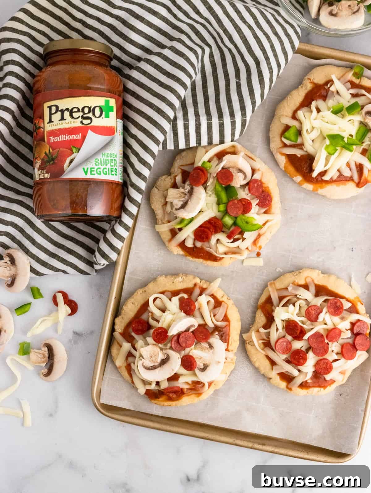 Pizza crust with sauce and toppings.