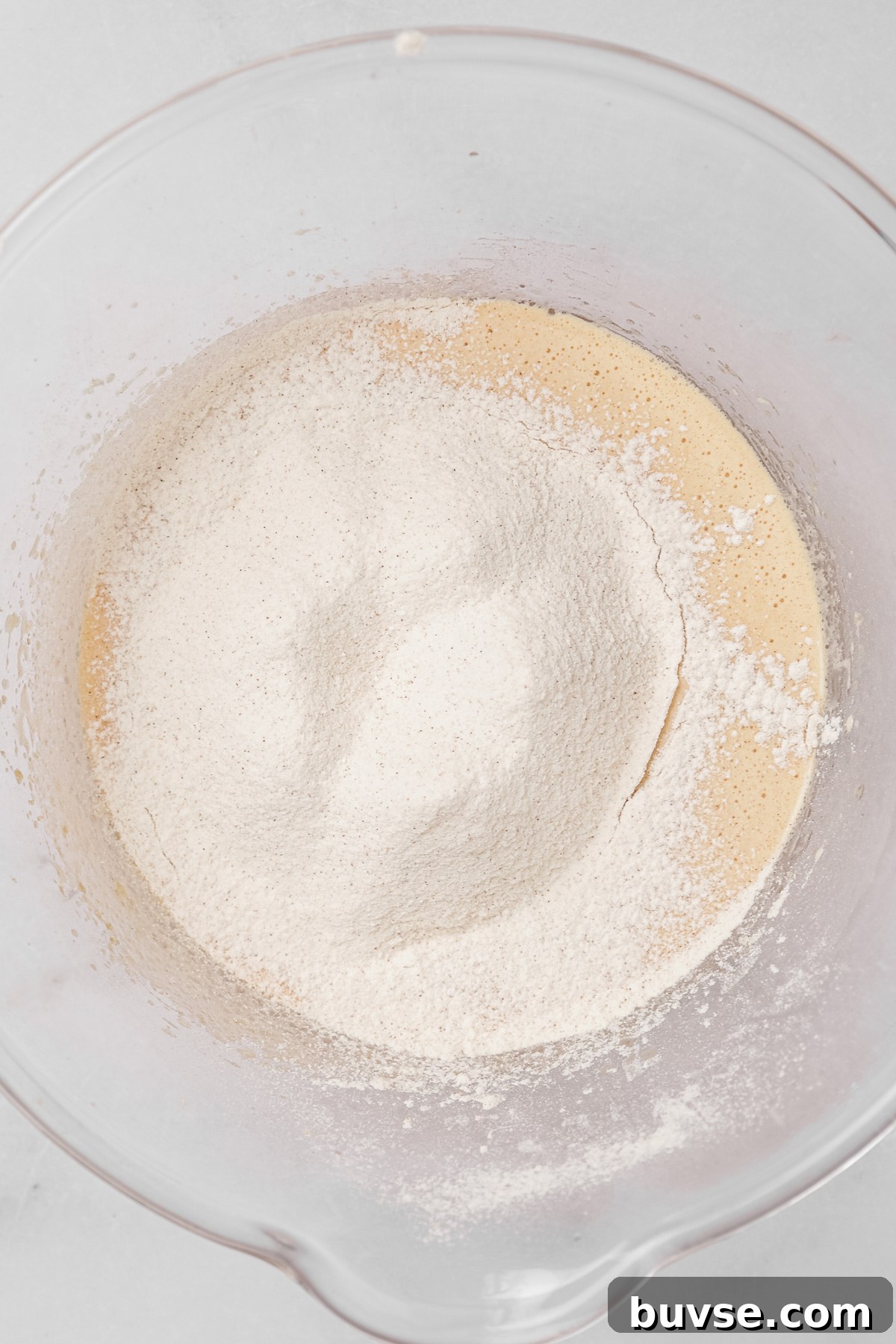 Mixing eggs, oil, sugar, and vanilla for carrot cake cupcakes batter