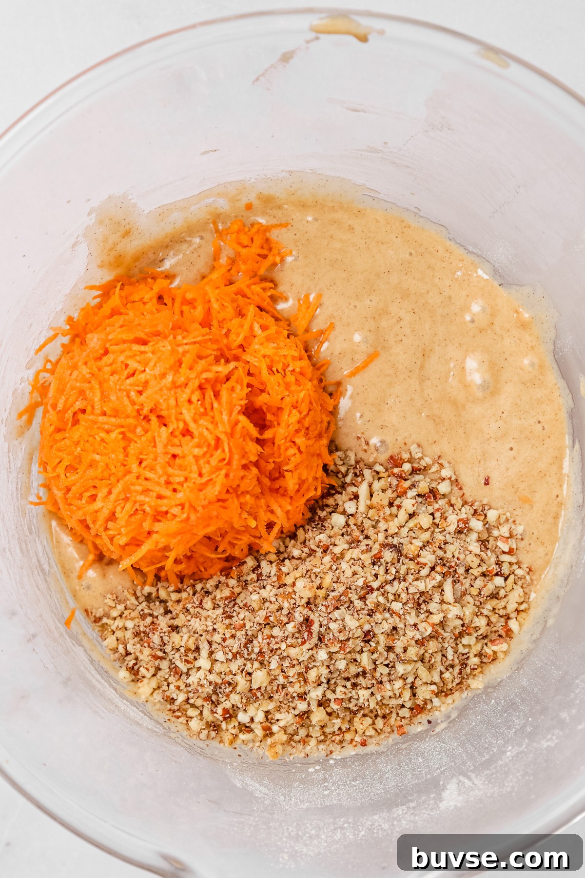 Carrot cake cupcakes batter with grated carrots and chopped nuts