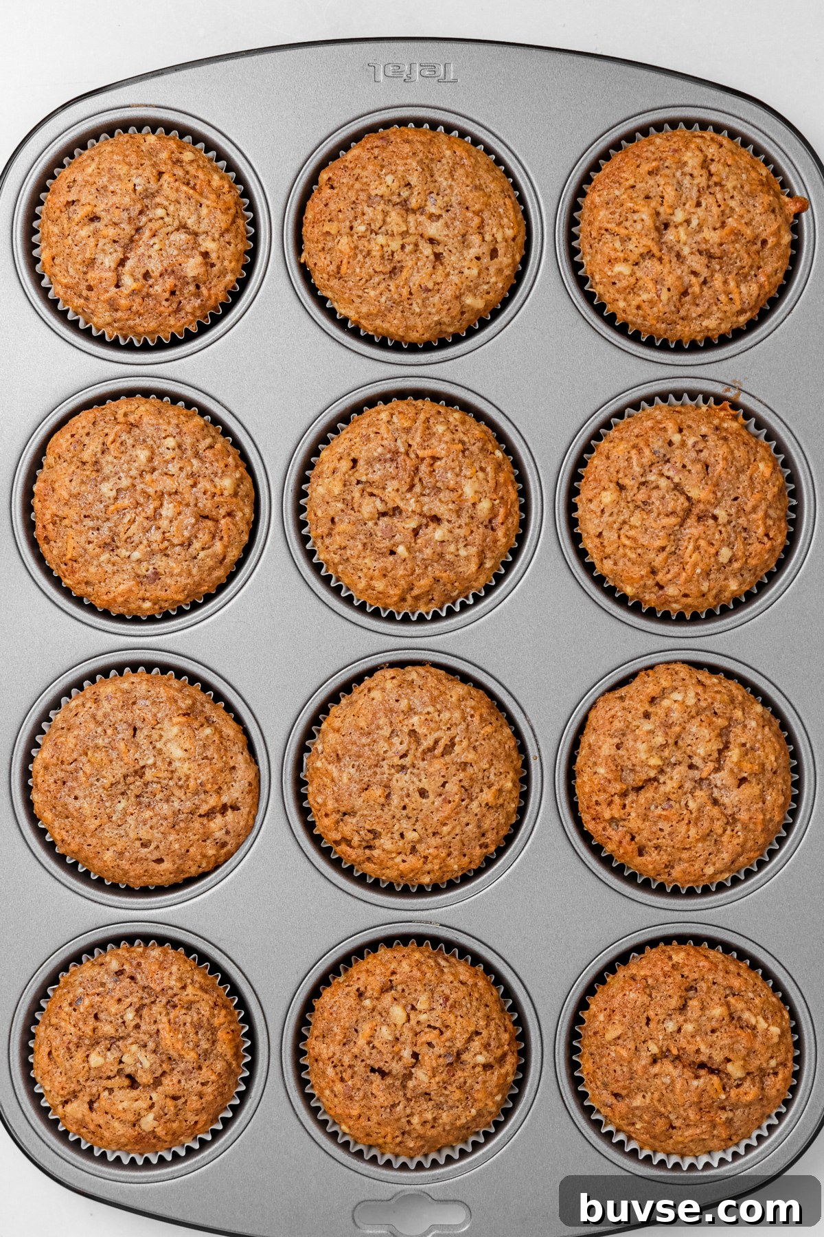 Freshly baked carrot cake cupcakes in a muffin tin