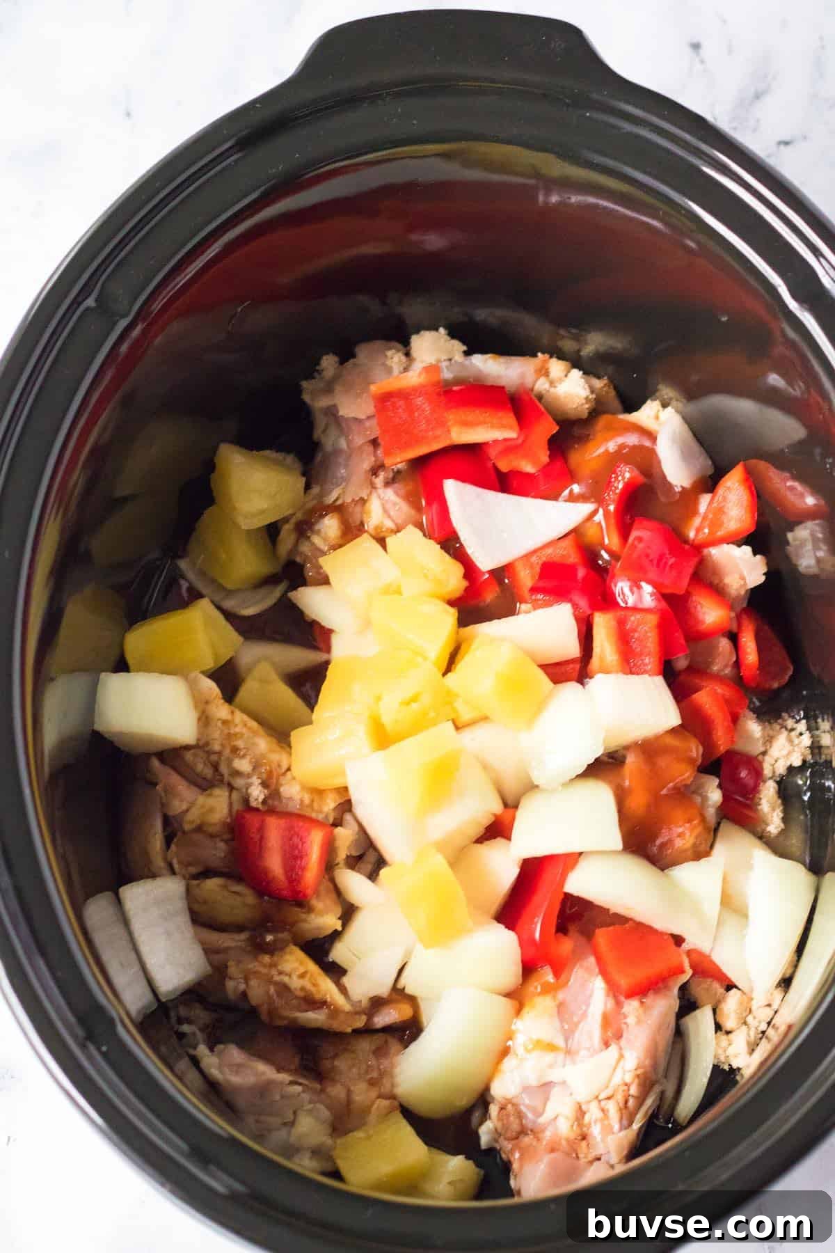 Ingredients to make crockpot Hawaiian chicken in a slow cooker.
