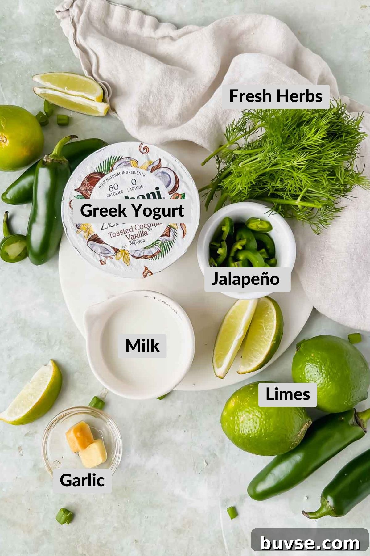 Homemade Creamy Jalapeno Sauce for Tacos and Dips 3 ingredients for creamy jalapeno sauce in individual bowls on green background.