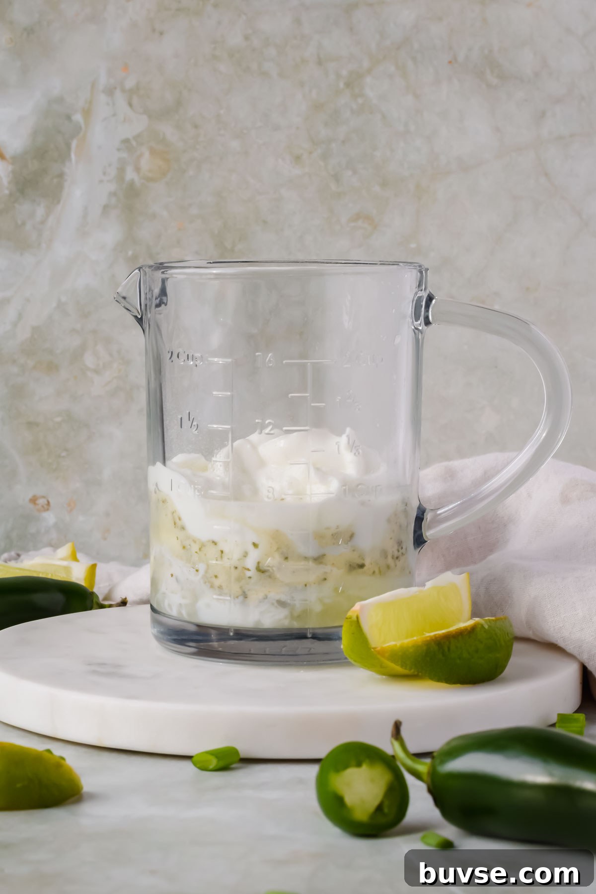 Homemade Creamy Jalapeno Sauce for Tacos and Dips 4 wet ingredients added to glass measuring cup waiting to be blended.