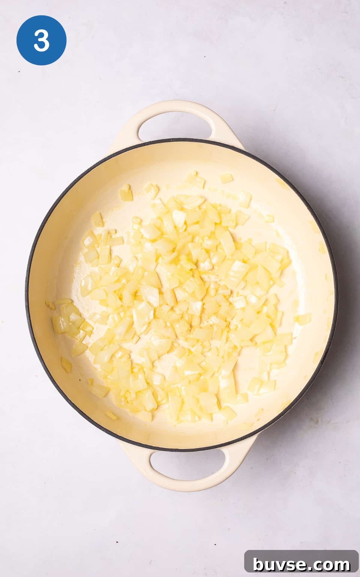 Sautéing onion and garlic in a pan.