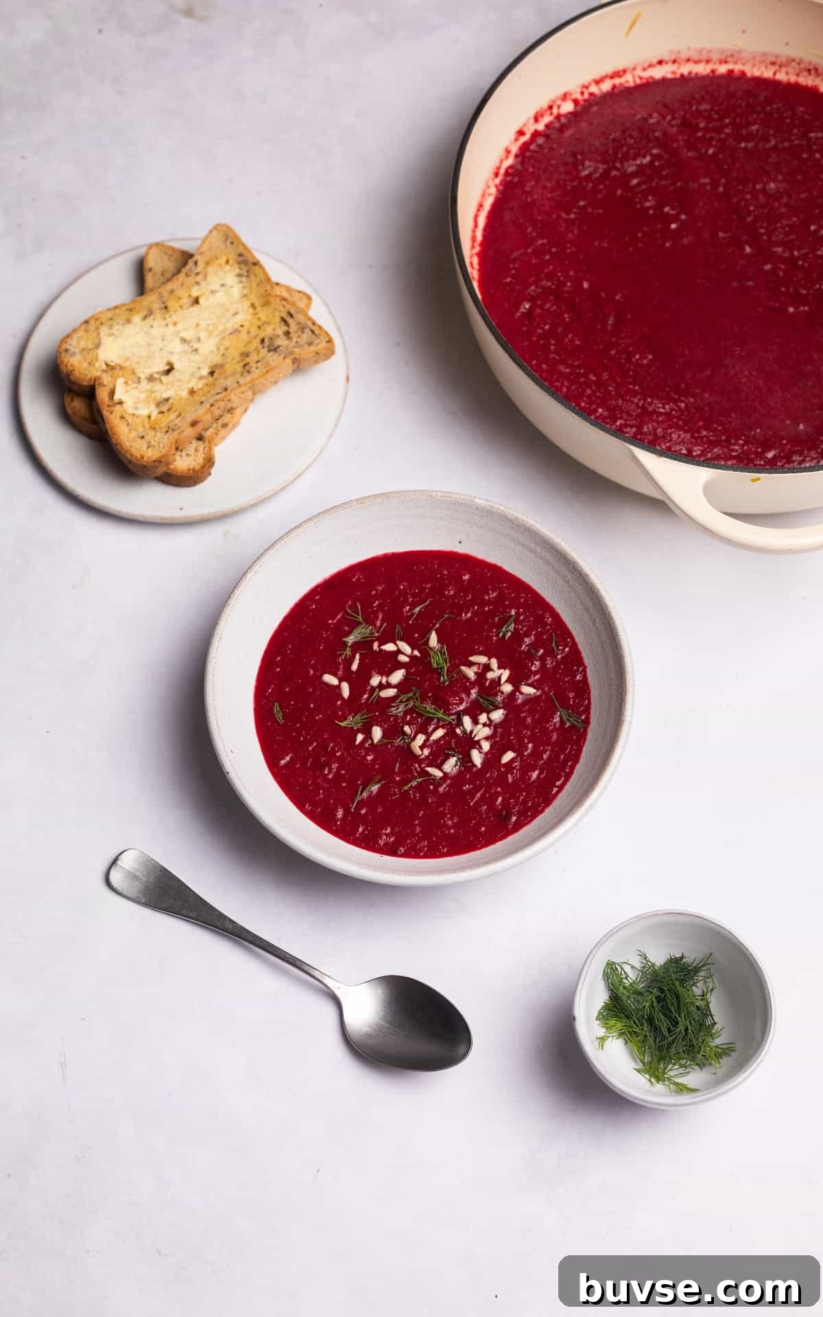 beetroot soup garnished with sunflower seeds.