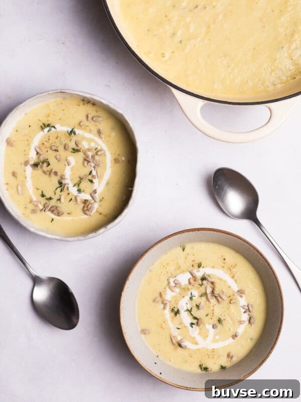 Parsnip soup with sunflower seeds served in bowls.