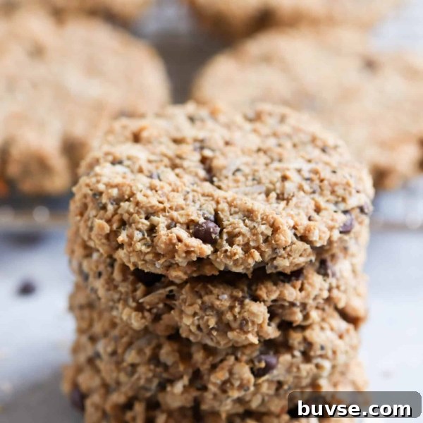 4 Breakfast Cookies stacked on top of eachother with more cookies in the background.