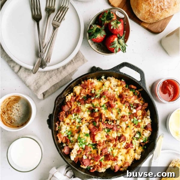 Plate of cheesy scrambled eggs with bacon and green onions, served with a slice of buttered toast. A fork is placed beside the food.