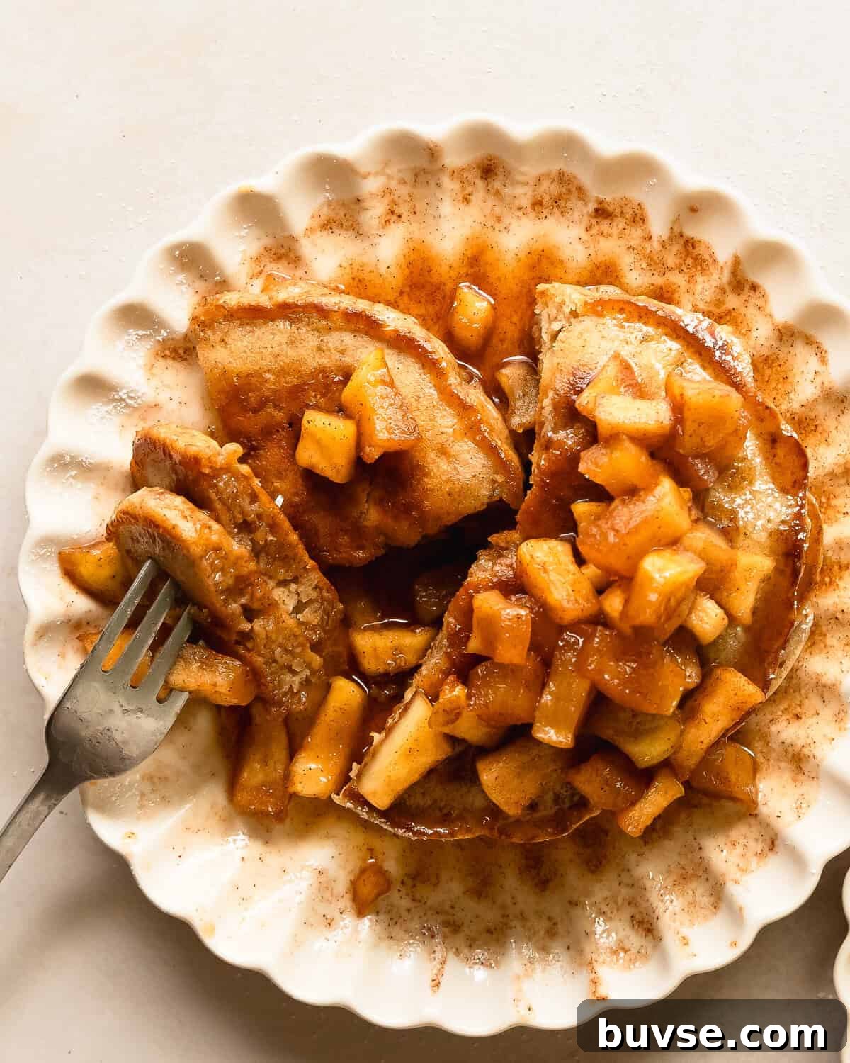 Apple cinnamon pancakes are light and fluffy pancakes made with tart grated apples. Top these melt in your mouth apple pancakes with an easy to make maple glazed, cinnamon spiced apple topping. These cinnamon apple pancakes make the best pancakes for a cozy and indulgent fall breakfast everyone will love.