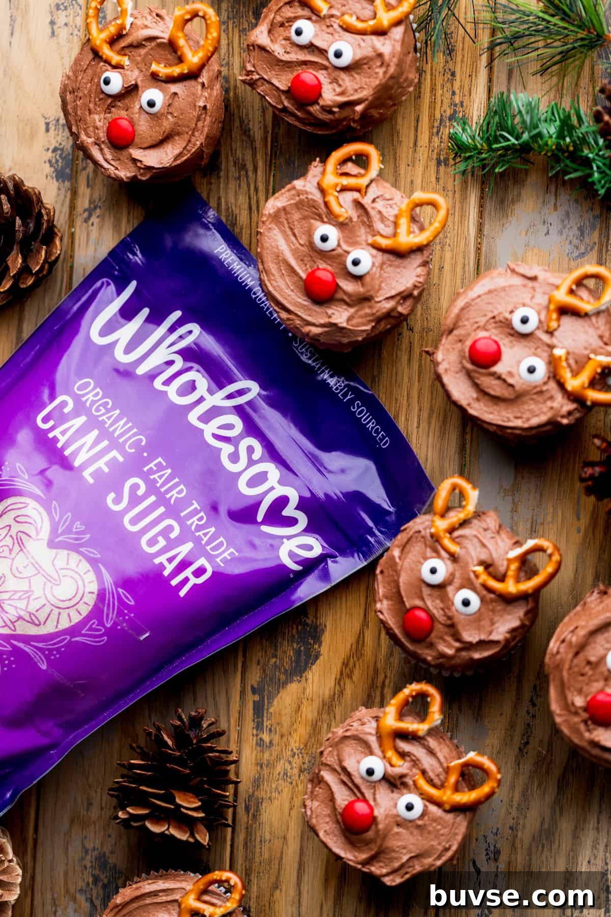 Cupcakes decorated like rudolph with a bag of sugar.