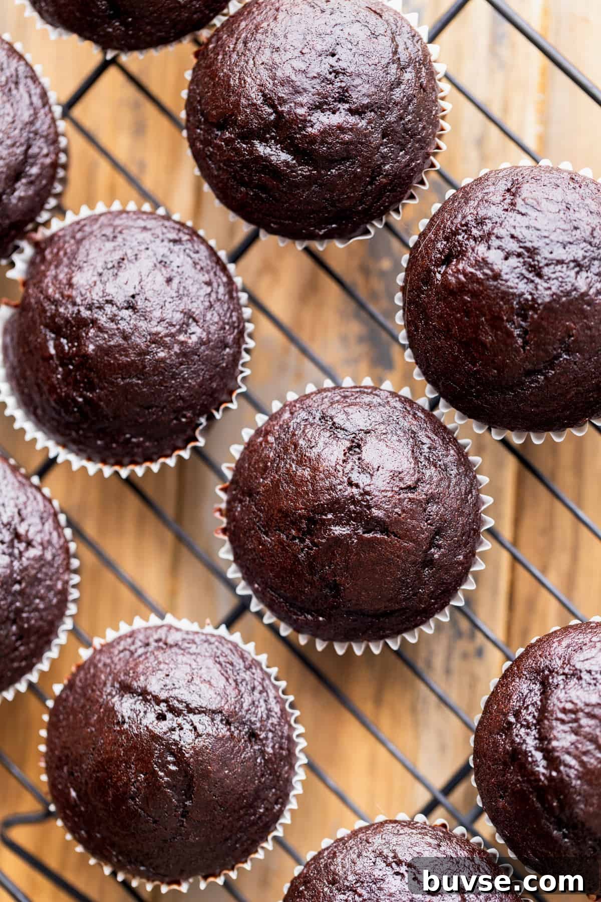 Baked cupcakes on a wire rack.