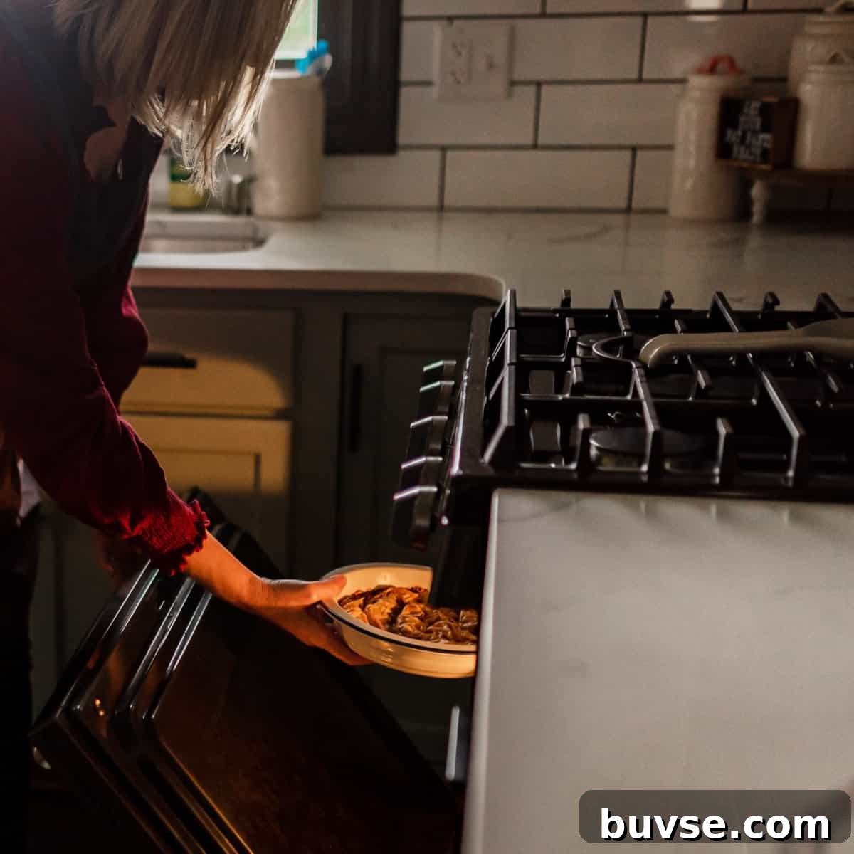 Phyllo Dough Recipes and Techniques 10 A woman taking phyllo pastry dish out of the oven.