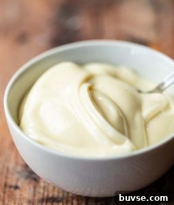 mayonnaise in small white bowl with teaspoon in