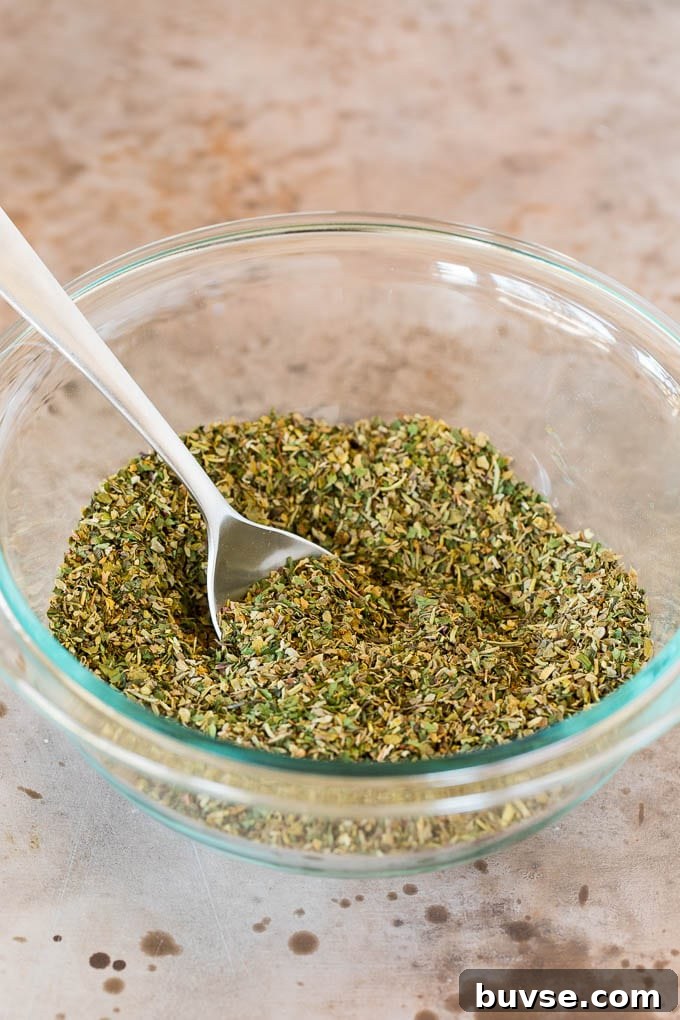 A bowl of seasoning blend with a spoon in it.