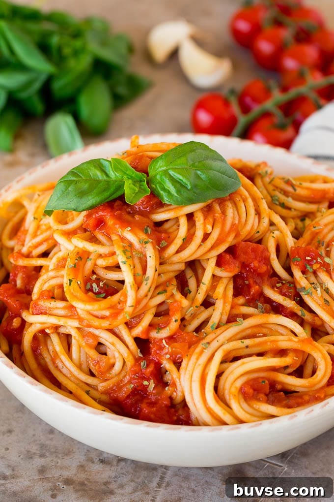 Italian seasoning sprinkled over a bowl of spaghetti.