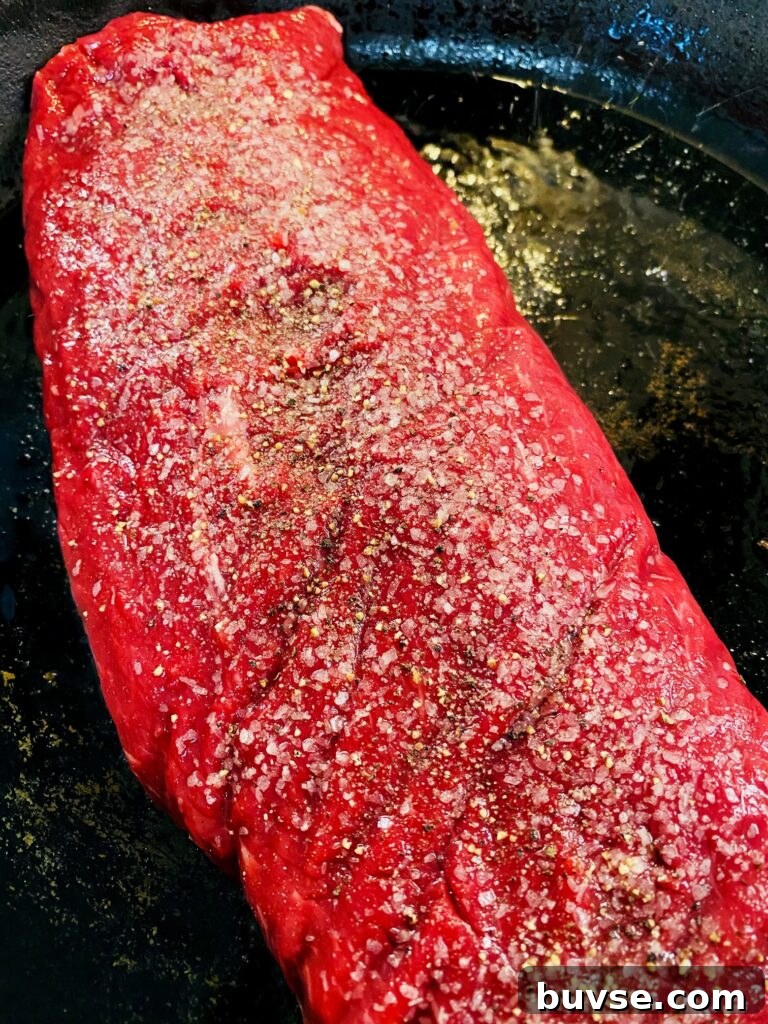 steak in cast iron pan before cooking