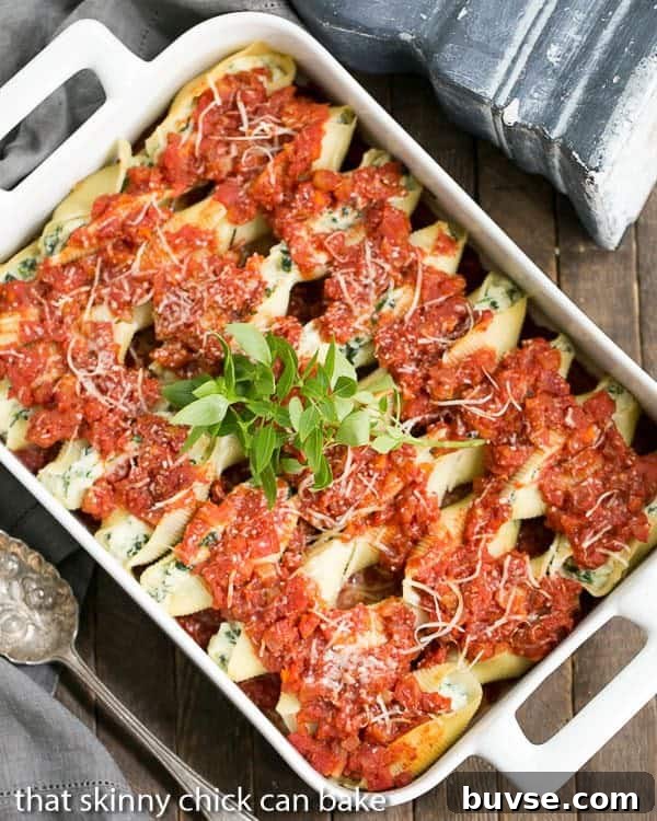 Spinach Stuffed Pasta Shells - A comforting casserole the whole family will adore! Spinach Stuffed Pasta Shells in a white ceramic casserole dish.