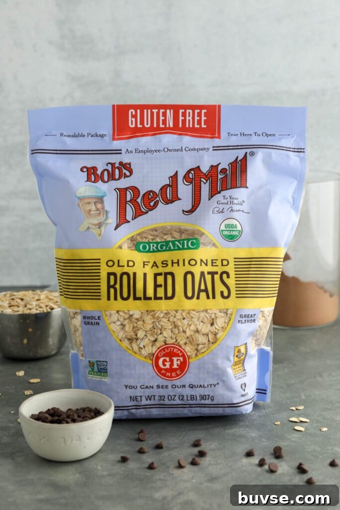 Brownie Batter Overnight Oats Recipe for Chocolate Lovers 4 Bob's Red Mill Organic Old Fashioned Rolled Oats bag on board with dark chocolate chips and oats and cacao powder