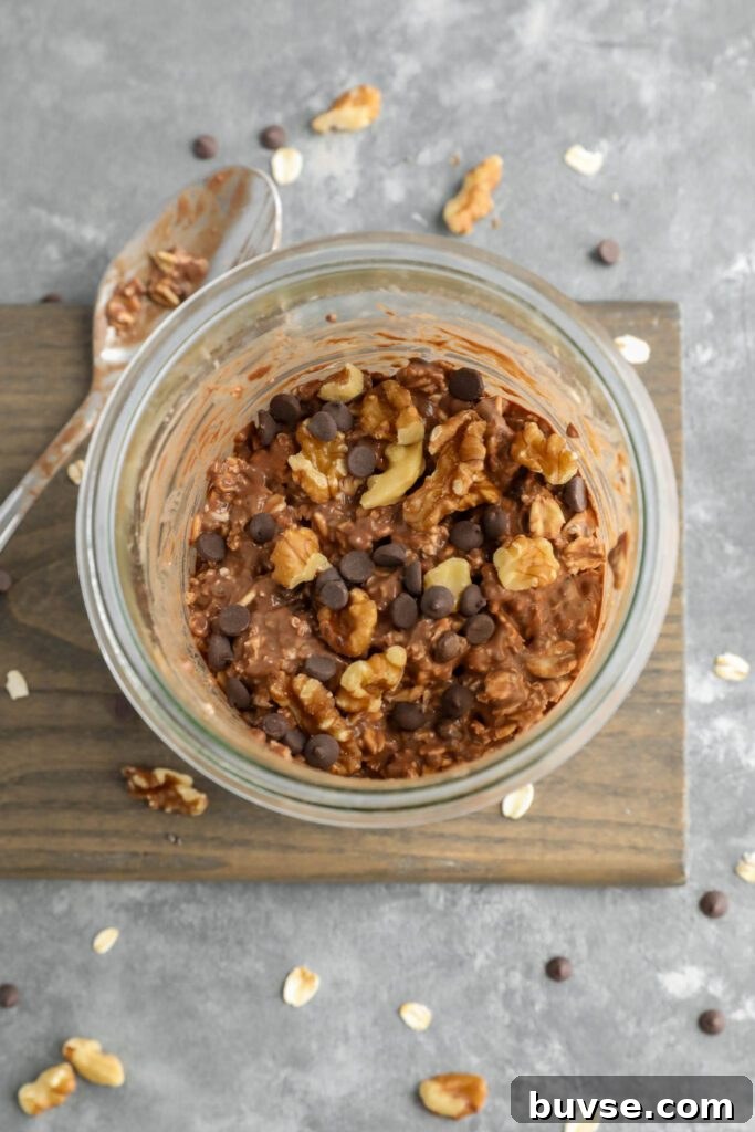 Brownie Batter Overnight Oats Recipe for Chocolate Lovers 10 brownie batter overnight oats mixed in jar with spoon on the side
