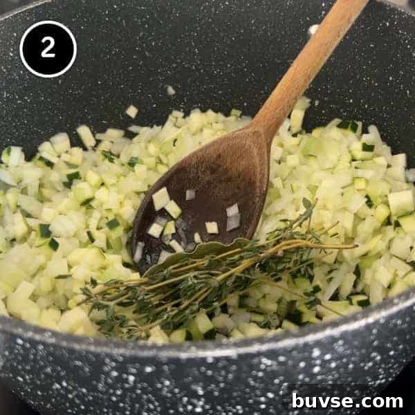Greek Lemon Orzo Soup with Chicken | cookeatworld.com Frying diced onion, celery and zucchini in a pan
