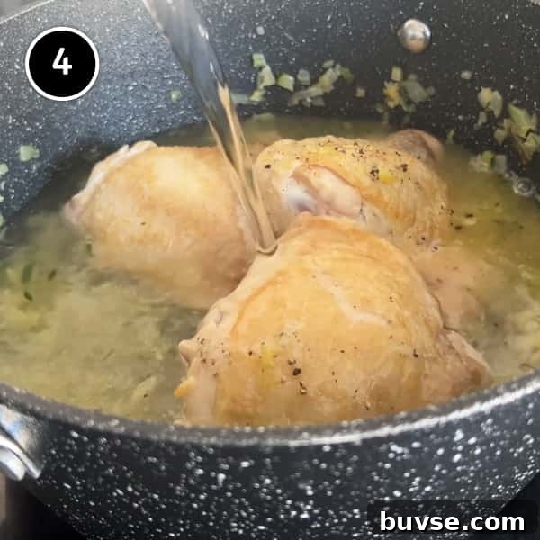 Greek Lemon Orzo Soup with Chicken | cookeatworld.com Topping up the soup ingredients with water.