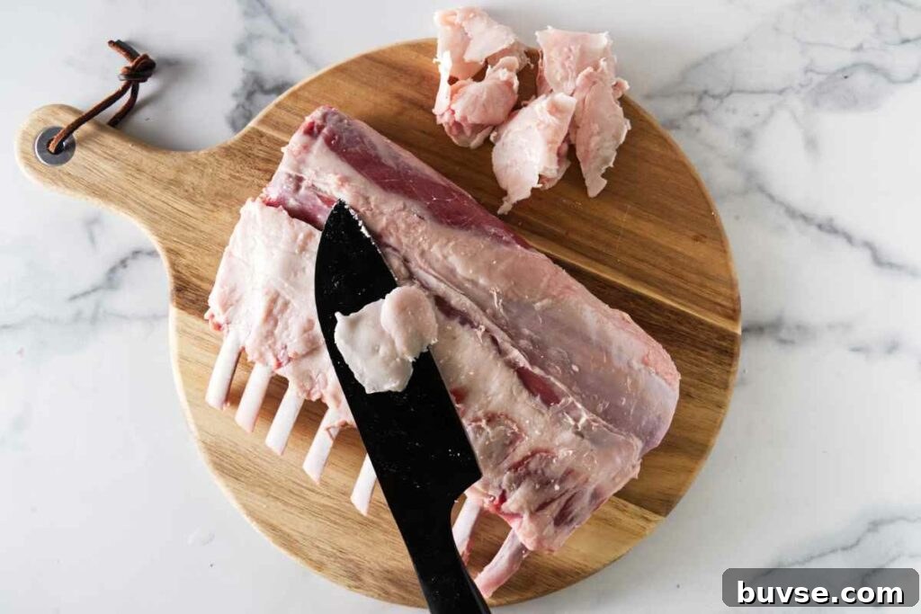 Trimming the fat off a rack of lamb.