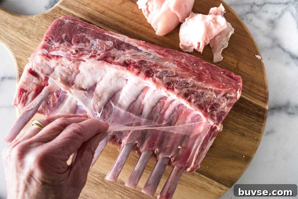 Removing the silver skin from a rack of lamb.