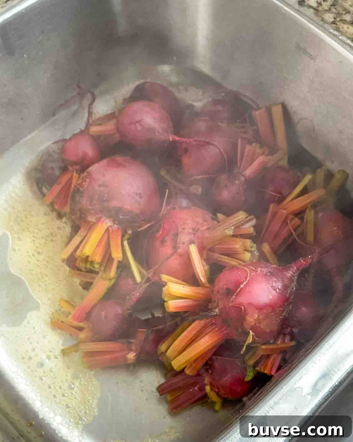 Homemade Old-Fashioned Pickled Beets Recipe 8 The cooked beets draining in the sink.