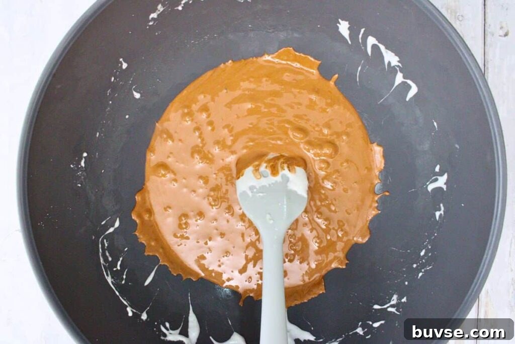stir brown food coloring into melted marshmallows