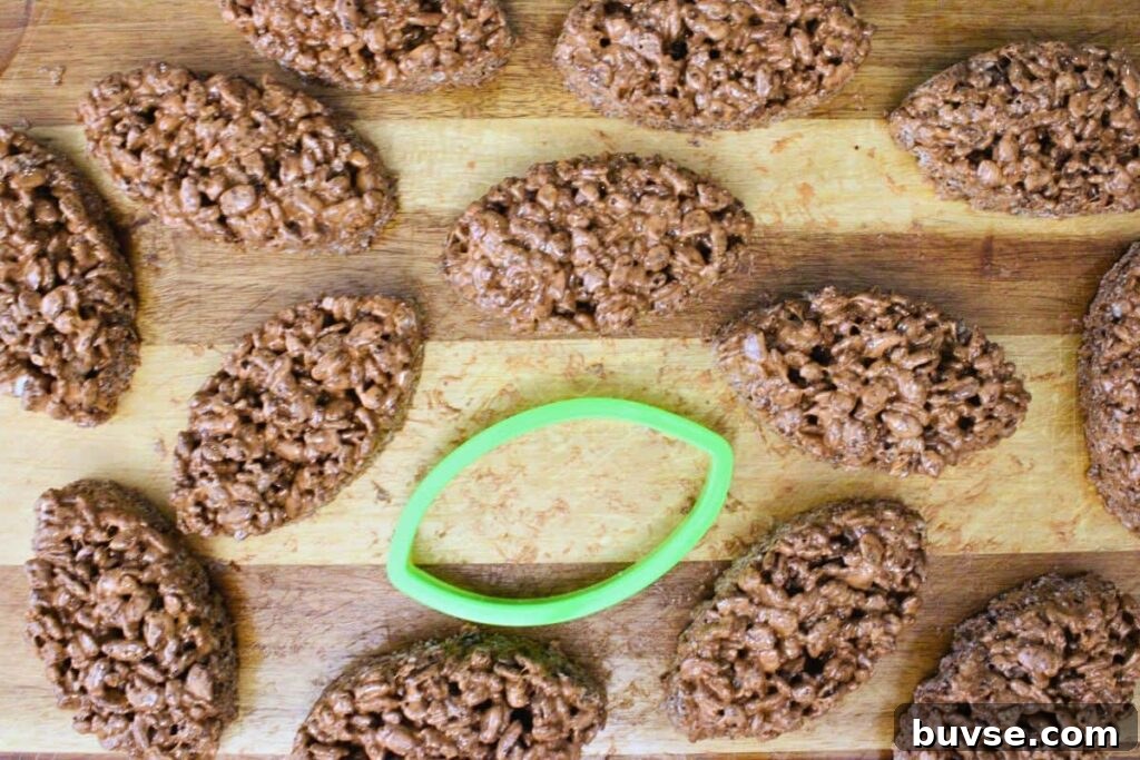 use a football shaped cookie cutter to cut rice krispies