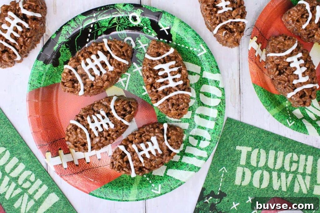 overhead view of football rice krispie treats on football plates and party napkins