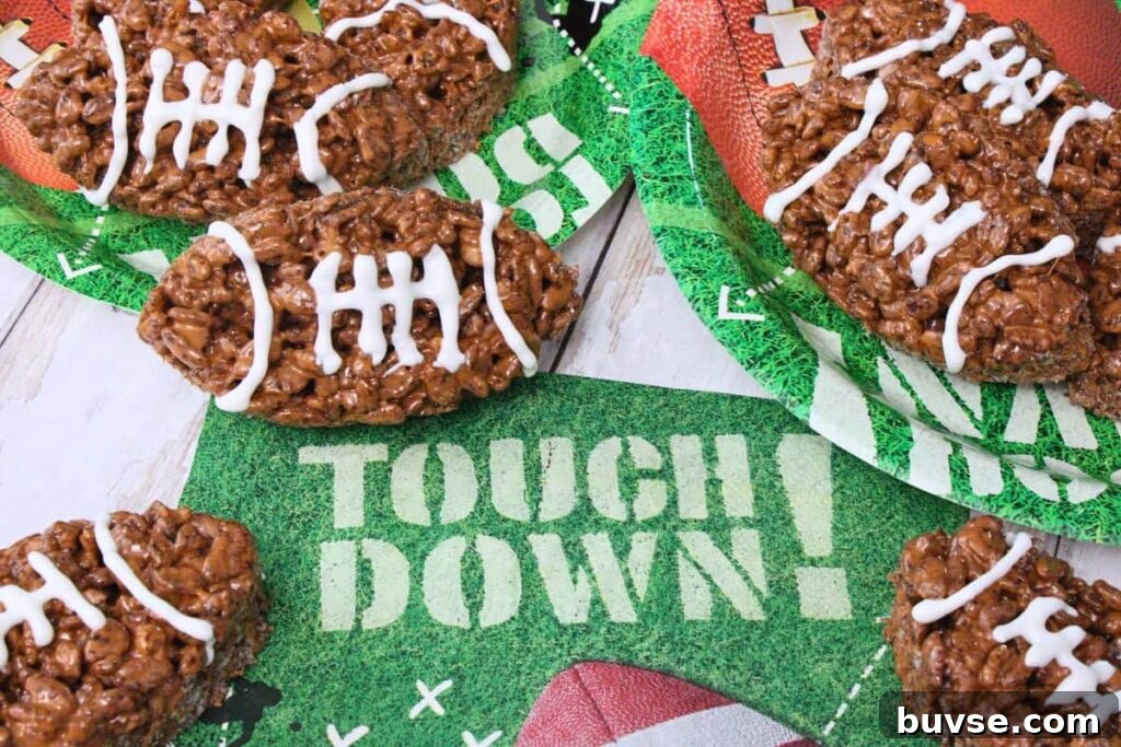 football rice krispie treats with icing spread out over football party plates and napkins